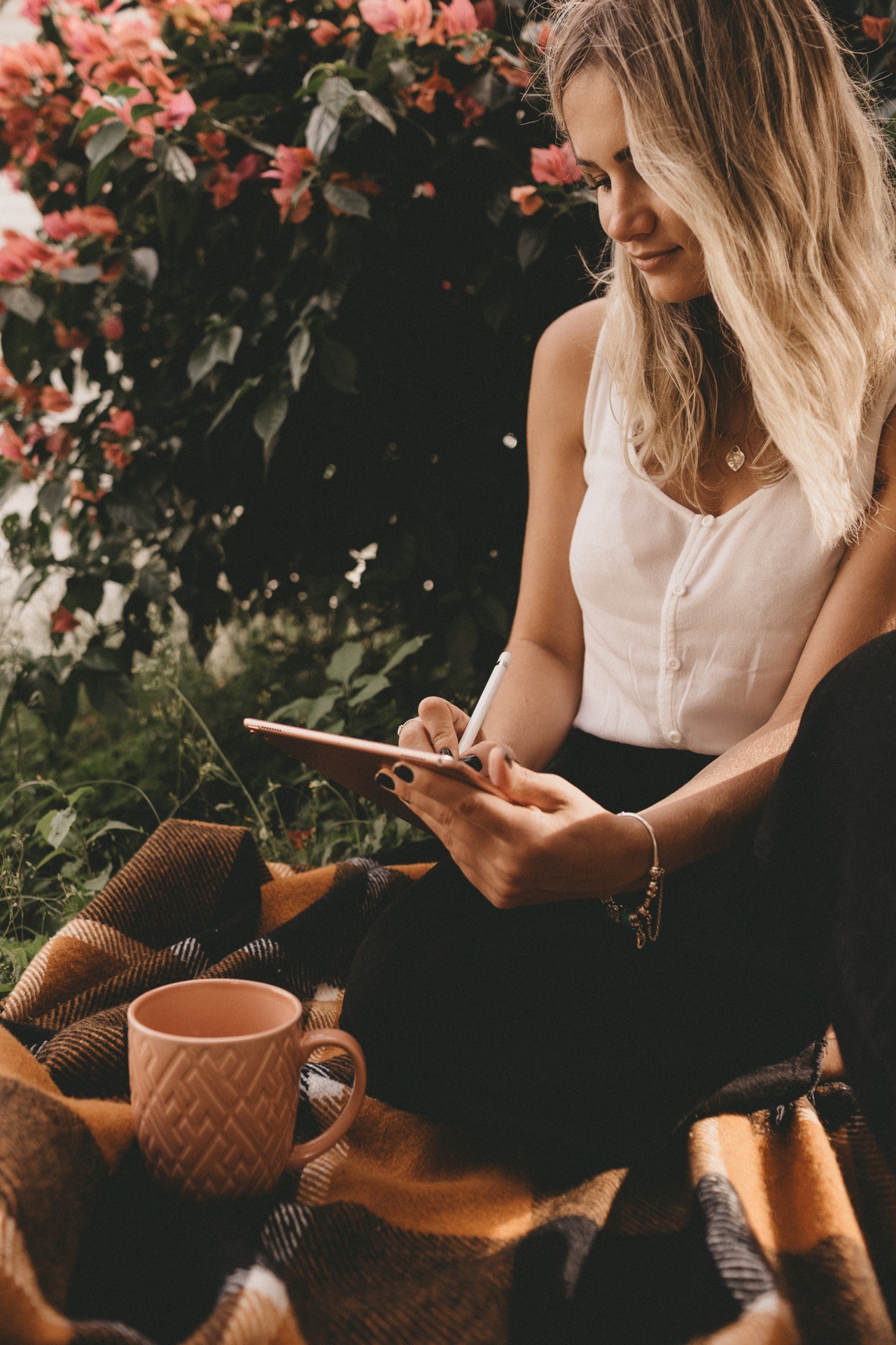 woman writing on iPad