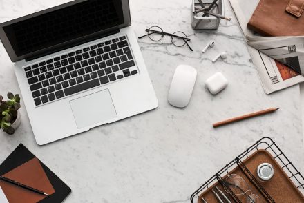 Apple computer on marble table.