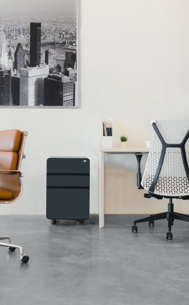 A minimalist NYC office with an open, modern setup of chairs and desks.
