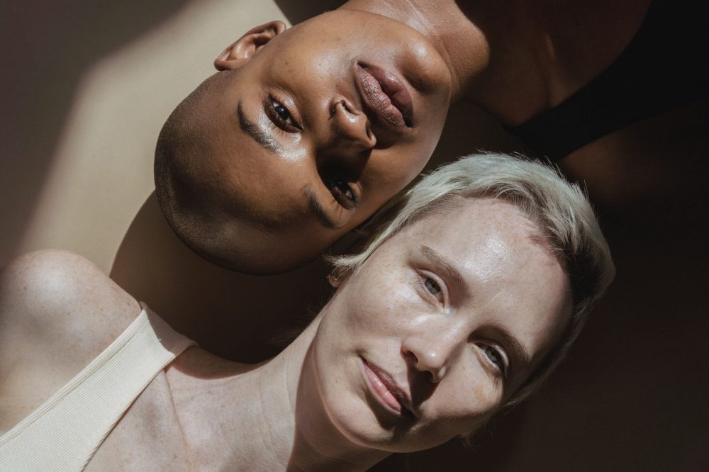 Multiracial female models lying on floor