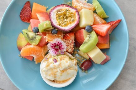 Tropical fruit and yogurt on a blue plate