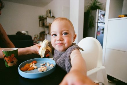 Baby eating in highchair